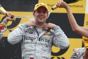 Jamie Green is helped with his celebrations after his DTM victory at the Norisring in June 2009